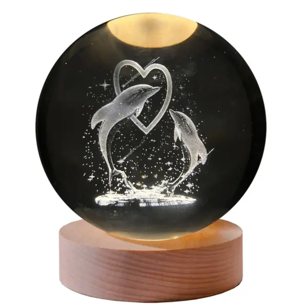 Illuminated crystal ball with dolphin and heart design